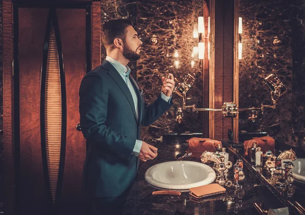 Confident well-dressed man using perfume — Stock Photo, Image