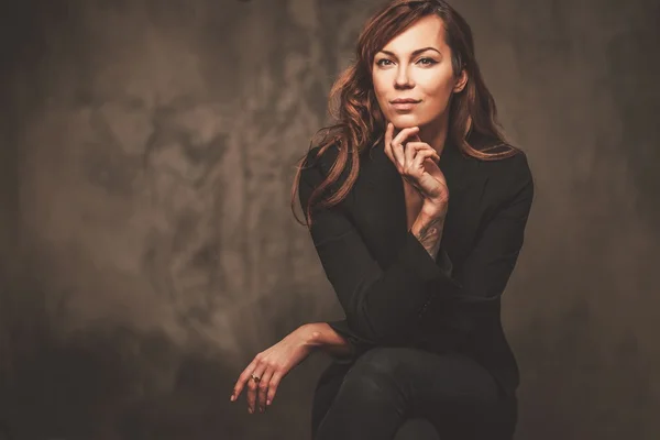 Woman in black sitting on chair — Stock Photo, Image