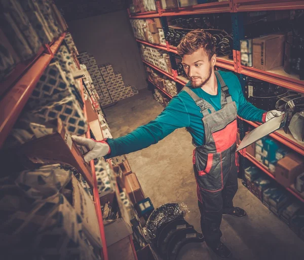 Worker on a automotive spare parts warehouse — Stock Photo, Image