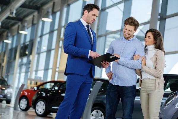 Salesman talking to a young couple — Stock Photo, Image