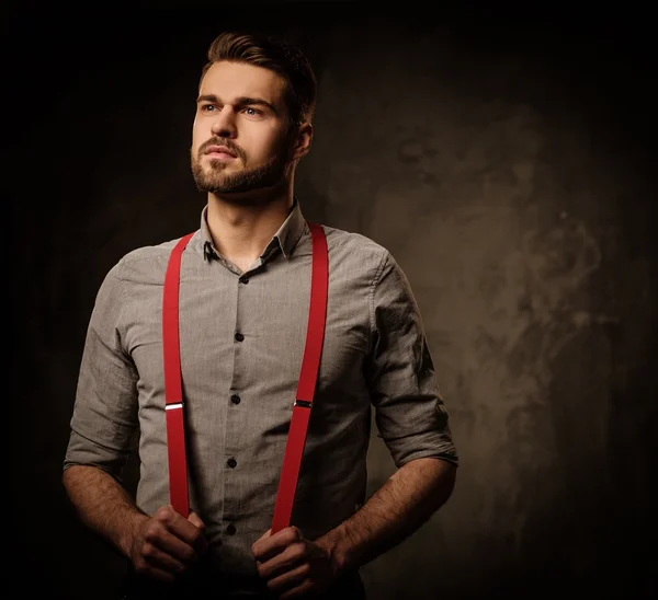 Jovem homem bonito com barba vestindo suspensórios — Fotografia de Stock