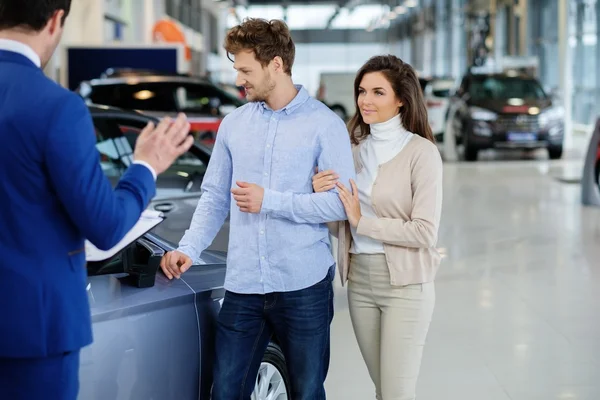 Verkäufer im Gespräch mit einem jungen Paar — Stockfoto