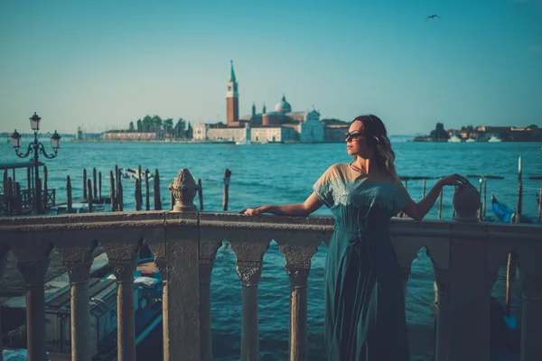 Hermosa mujer bien vestida de pie cerca de la plaza San Marco con góndolas y la isla de Santa Lucía en el fondo . — Foto de Stock