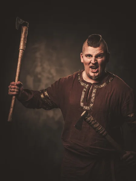 Serious viking with ax in a traditional warrior clothes — Stock Photo, Image