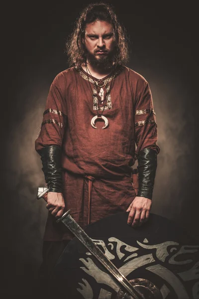 Boze viking met zwaard in de kleren van een traditionele warrior — Stockfoto