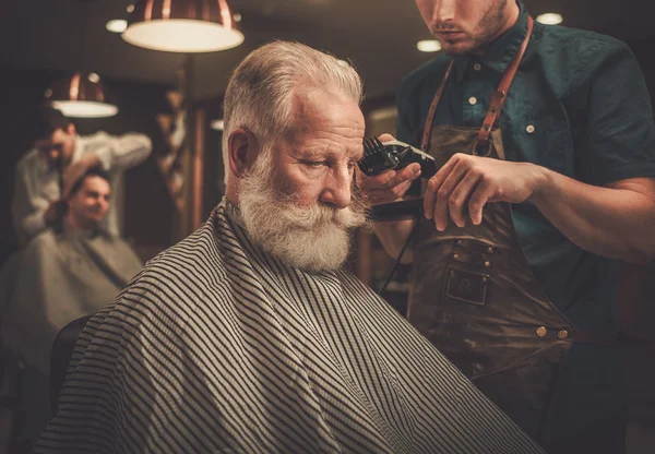 Homem sênior visitando cabeleireiro na barbearia . — Fotografia de Stock