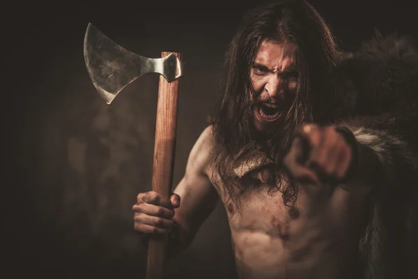 Angry viking with ax in a traditional warrior clothes — Stock Photo, Image