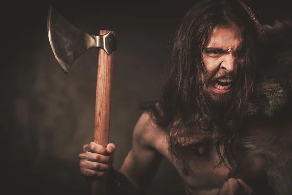 Angry viking with ax in a traditional warrior clothes — Stock Photo, Image