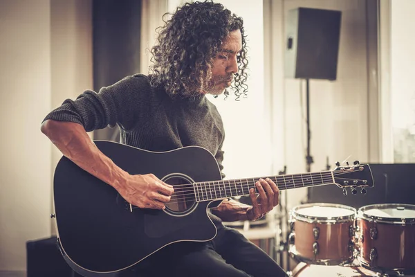 Curly gitarrist spela akustisk gitarr . — Stockfoto