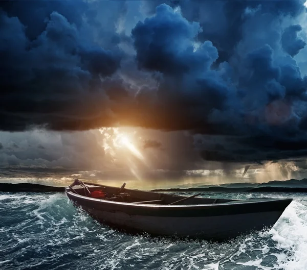 Wooden boat in a stormy sea — Stock Photo, Image