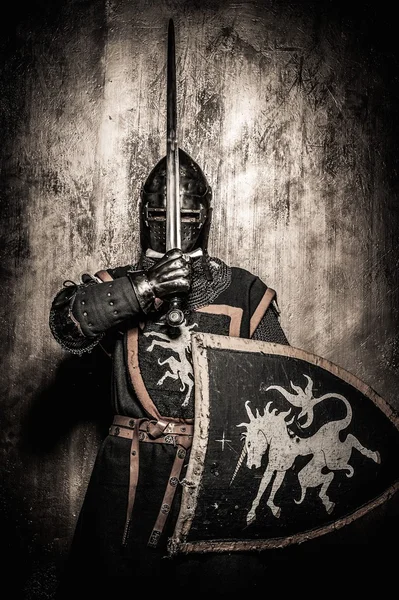 Medieval knight  holding sword in front of his face — Stock Photo, Image