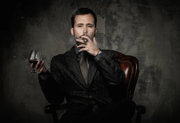 Handsome well-dressed with glass of beverage and cigar — Stock Photo, Image