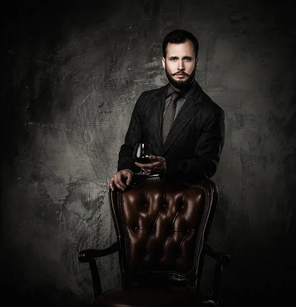 Handsome well-dressed with glass of beverage — Stock Photo, Image