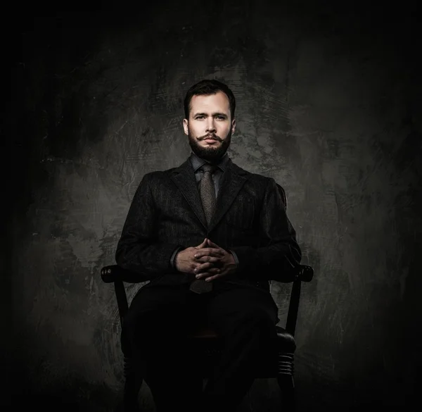 Handsome well-dressed  sitting in leather chair — Stock Photo, Image