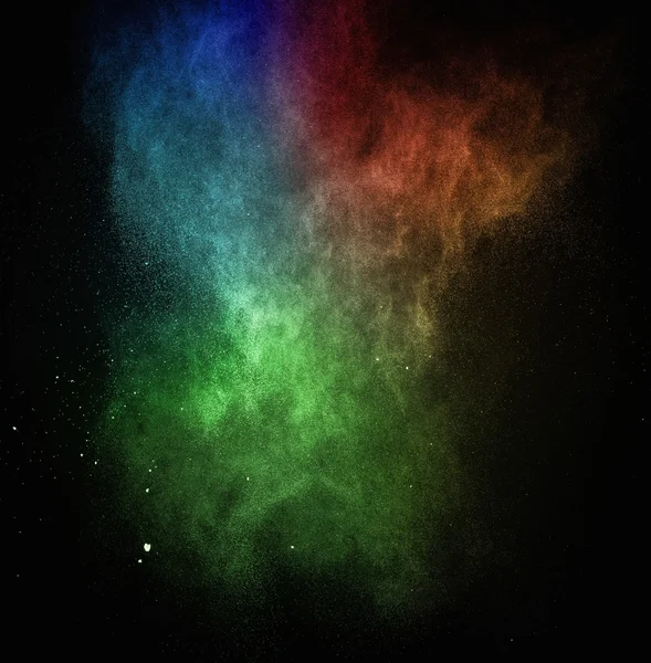 Pó colorido explodindo isolado em preto — Fotografia de Stock
