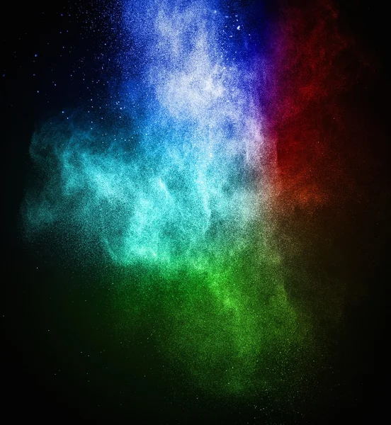 Colourful powder exploding isolated on black — Stock Photo, Image