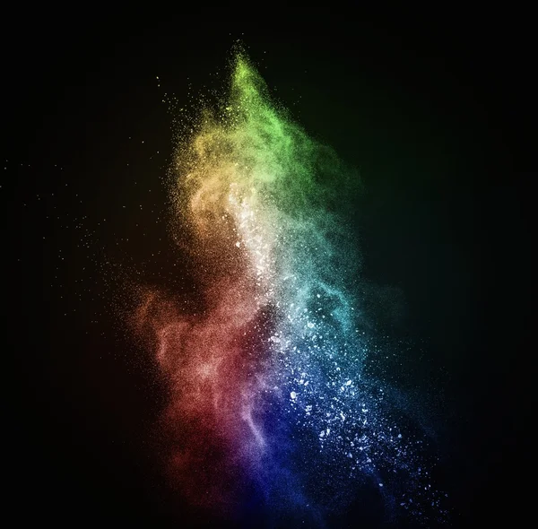 Colourful powder exploding isolated on black — Stock Photo, Image