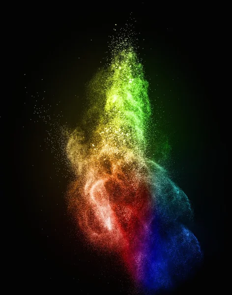 Colourful powder exploding isolated on black — Stock Photo, Image