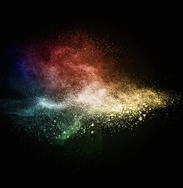 Colourful powder exploding isolated on black — Stock Photo, Image