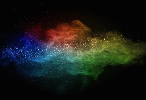 Colourful powder exploding isolated on black — Stock Photo, Image