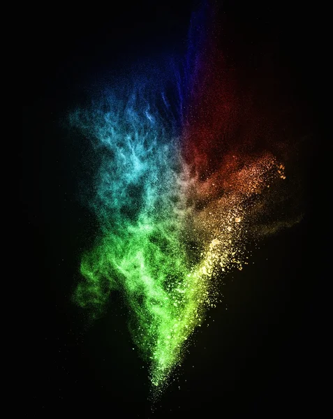 Colourful powder exploding isolated on black — Stock Photo, Image