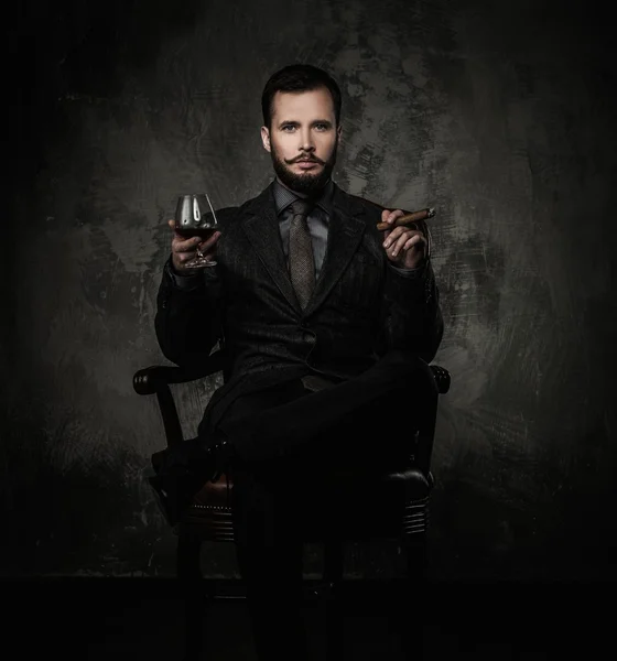 Handsome well-dressed with glass of beverage and cigar — Stock Photo, Image