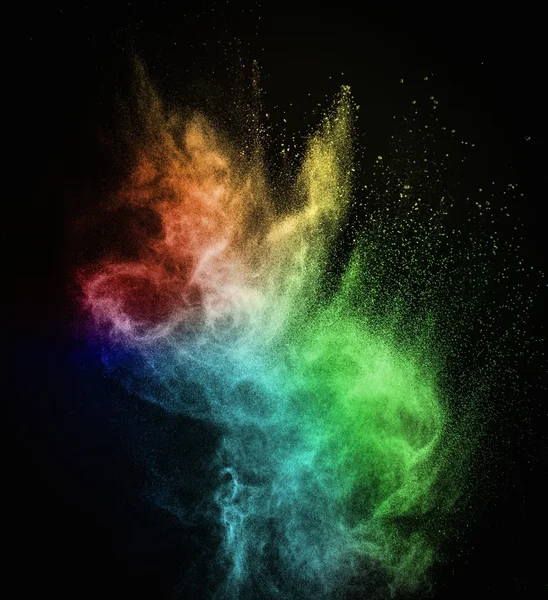 Colourful powder exploding isolated on black — Stock Photo, Image