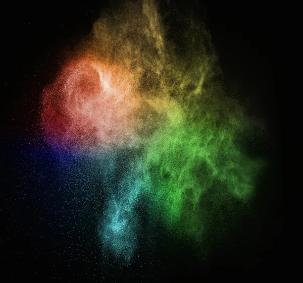 Colourful powder exploding isolated on black — Stock Photo, Image