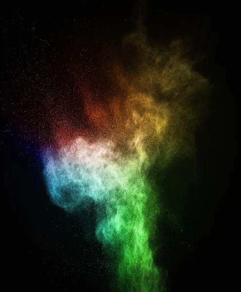 Colourful powder exploding isolated on black — Stock Photo, Image