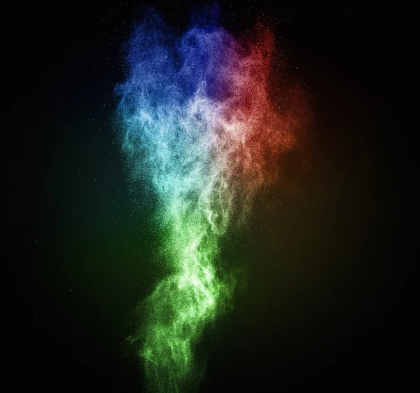 Colourful powder exploding isolated on black — Stock Photo, Image