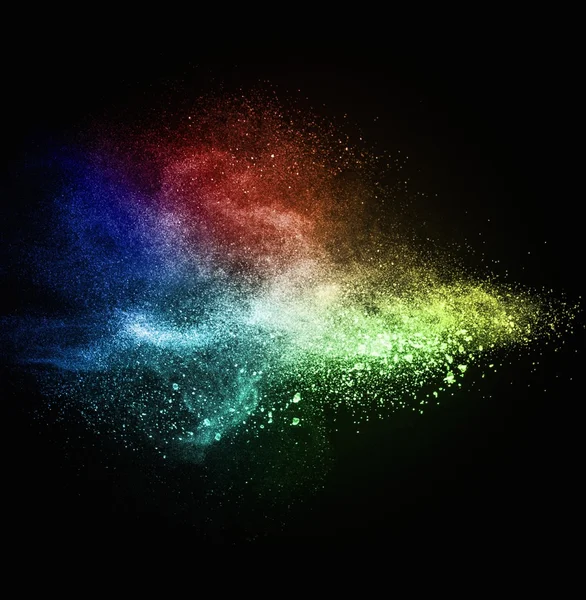 Colourful powder exploding isolated on black — Stock Photo, Image