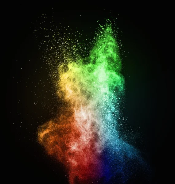 Colourful powder exploding isolated on black — Stock Photo, Image