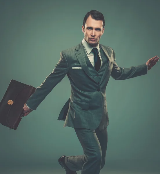 Well-dressed young businessman with a briefcase — Stock Photo, Image