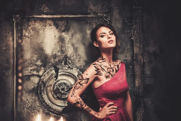 Tattooed beautiful woman in old spooky interior — Stock Photo, Image