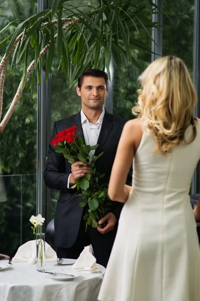 Bel homme avec un tas de roses rouges sortir ensemble sa dame — Photo