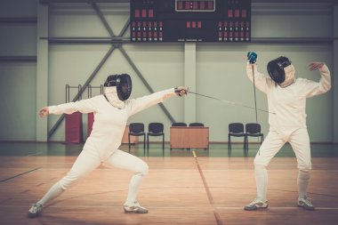 Two women fencers on a training  clipart