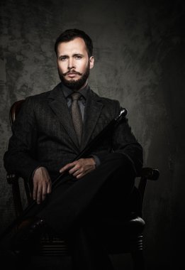 Handsome well-dressed  sitting in leather chair   clipart