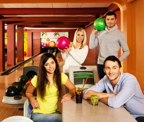 Skupina mladých lidí za stolem v bowling Clubu — Stock fotografie