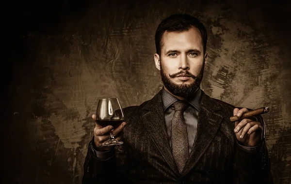 Handsome well-dressed with glass of beverage and cigar — Stock Photo, Image