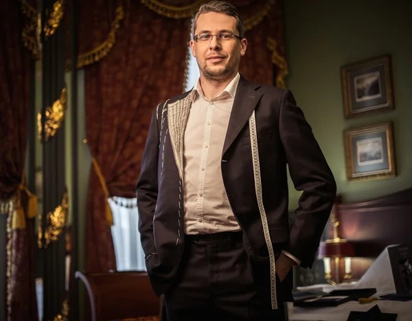 Middle-aged man trying on custom made suit in luxury vintage interior — Stock Photo, Image