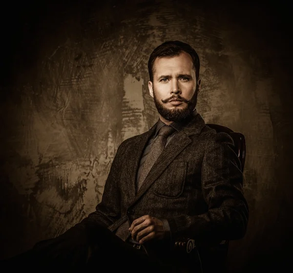 Handsome well-dressed  sitting in leather chair — Stock Photo, Image