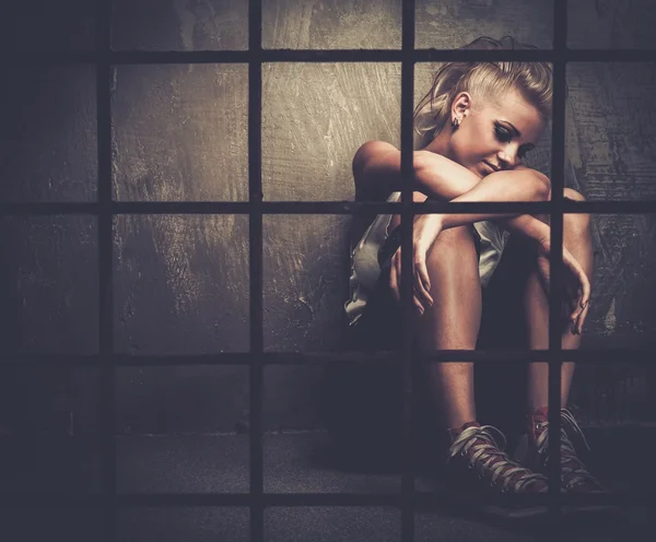 Troubled teenager girl behind bars — Stock Photo, Image