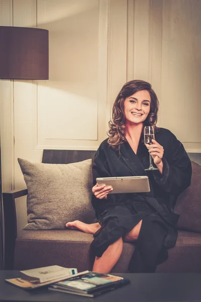 Woman in bathrobe relaxing with glass of champagne — Stock Photo, Image