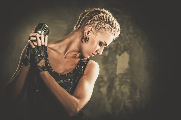 Attractive steam punk singer with microphone — Stock Photo, Image