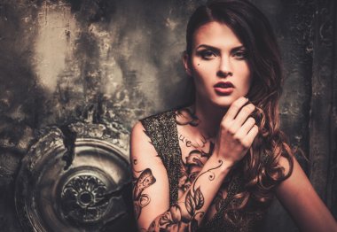 Tattooed woman in old spooky interior clipart