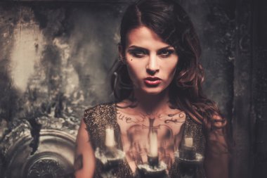 Tattooed woman in old spooky interior clipart