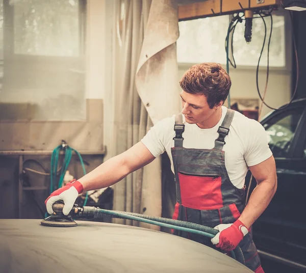 Young serviceman performing grinding with machine — Stock Photo, Image