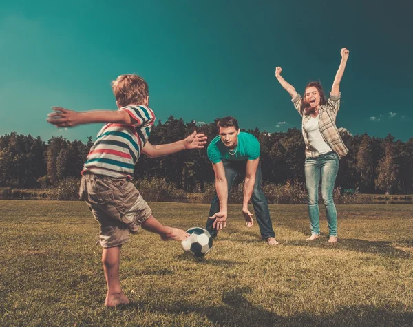 Family playing football outdoors — Stock Photo, Image