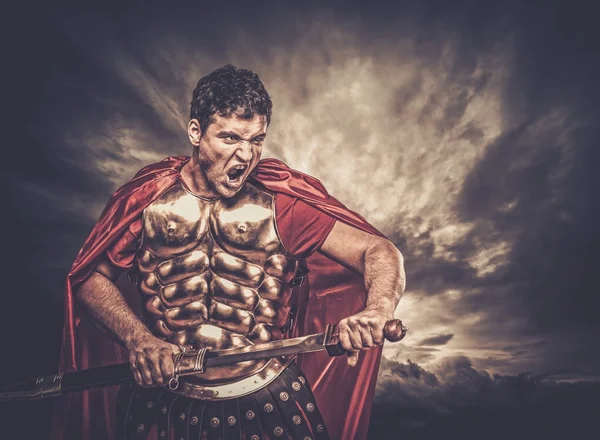 Legionary soldier against stormy sky — Stock Photo, Image