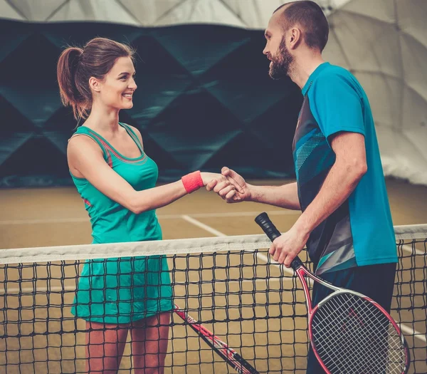 Mulher jogador de tênis apertando a mão com seu treinador — Fotografia de Stock